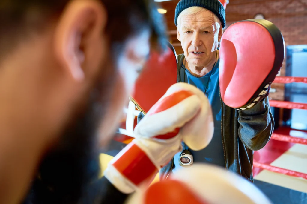 senior coach training boxer