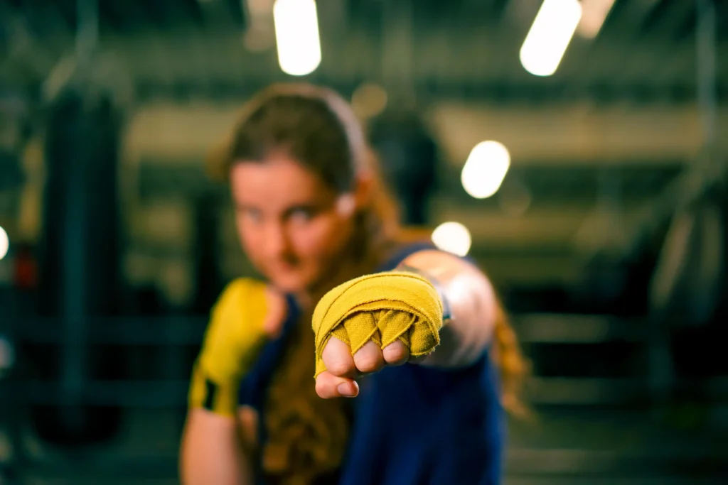 portrait-focused-boxer-girl-in-yellow-boxing-banda
