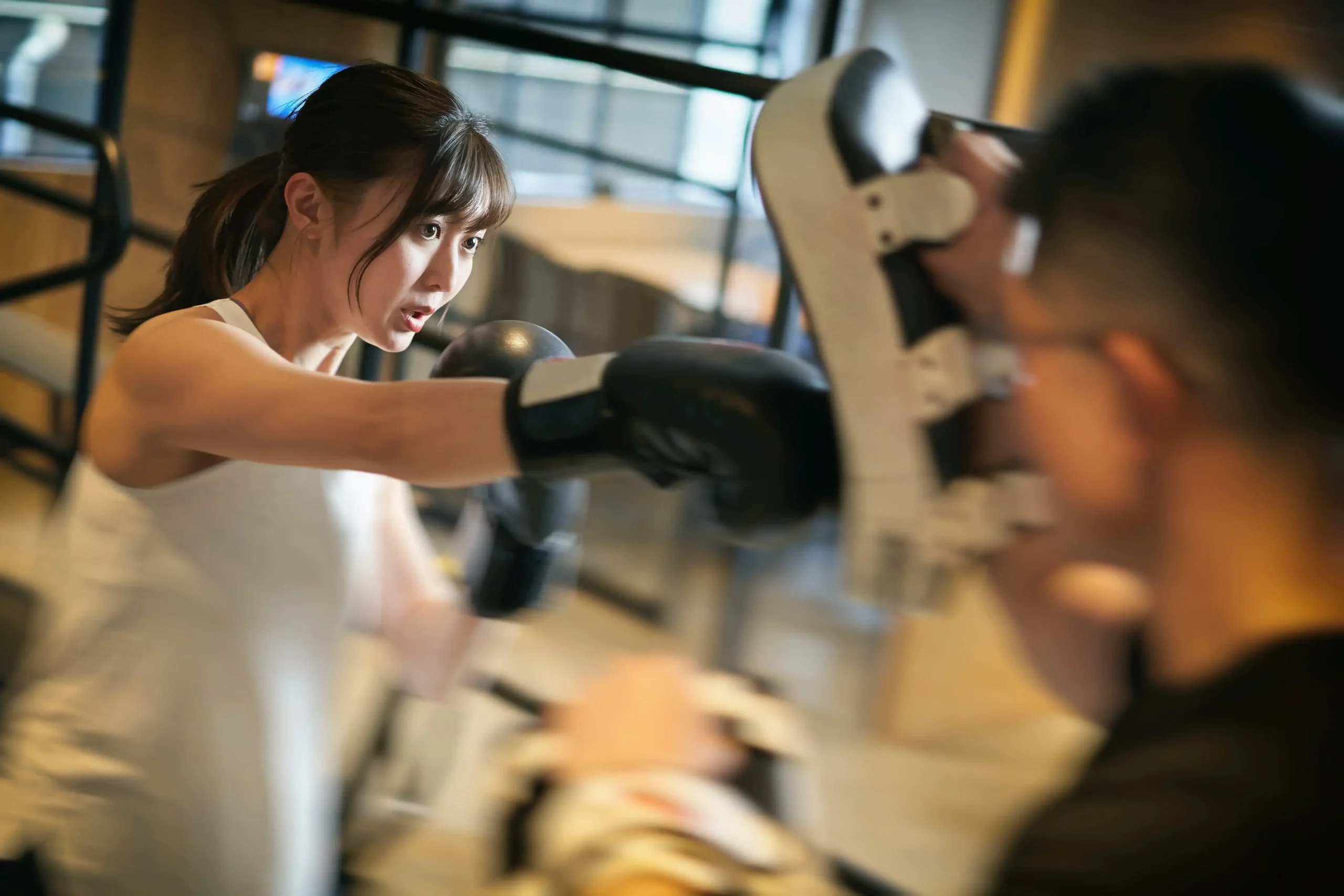 asian-woman-learning-kickboxing-from-a-personal-trainer