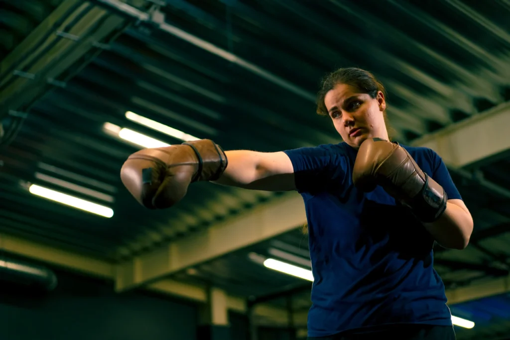 portrait of a woman in boxing gloves posing